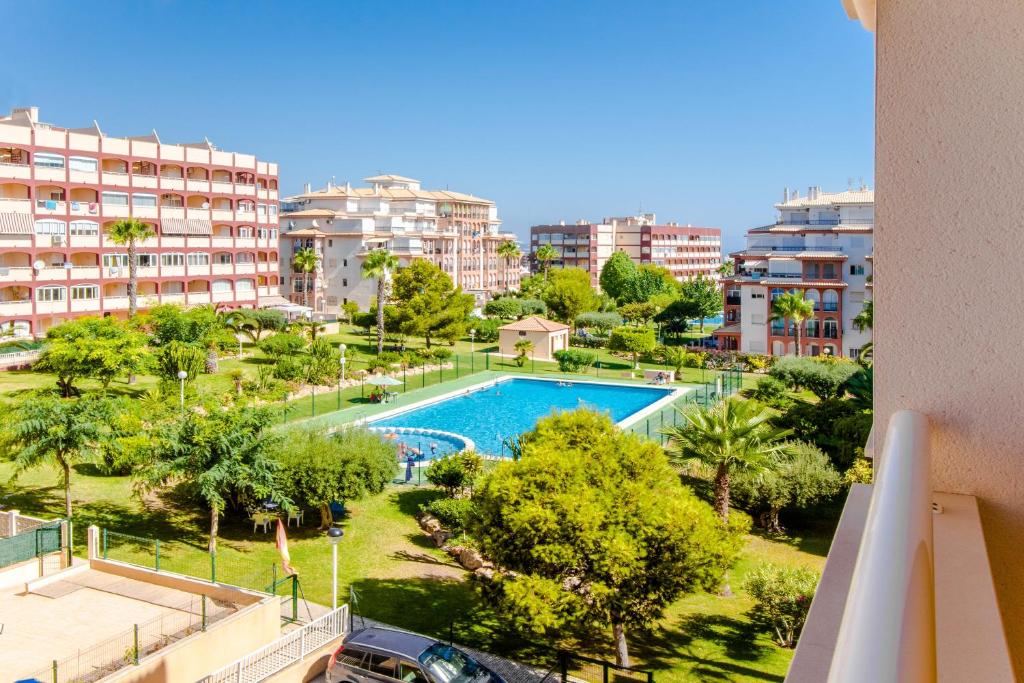 a view of a swimming pool in a city with buildings at Espanatour TORREMAR in La Mata