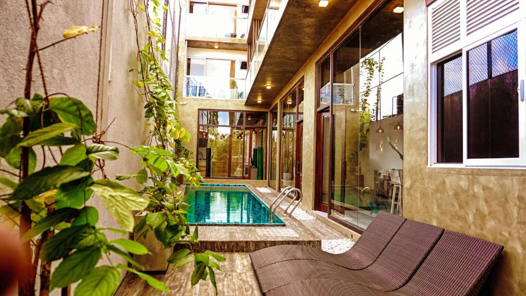 a house with a swimming pool in the middle of a building at Hotel Sico in Negombo