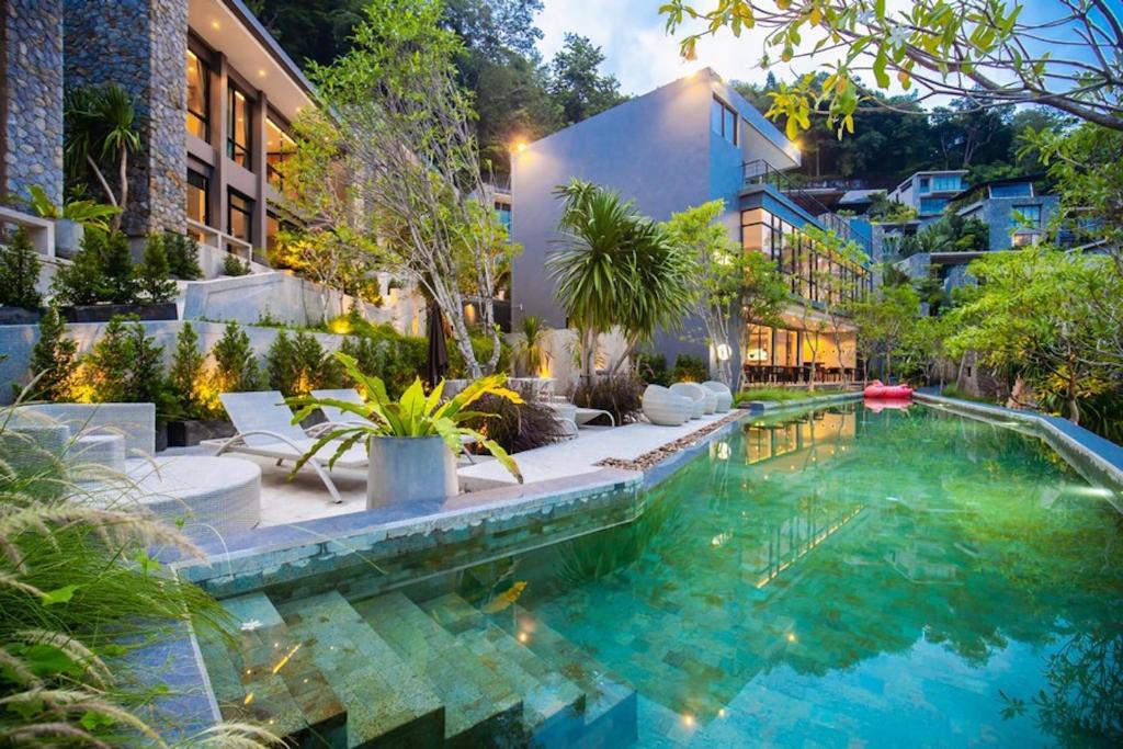 a swimming pool in the middle of a house at The Woods Natural Park Resort Phuket in Kamala Beach