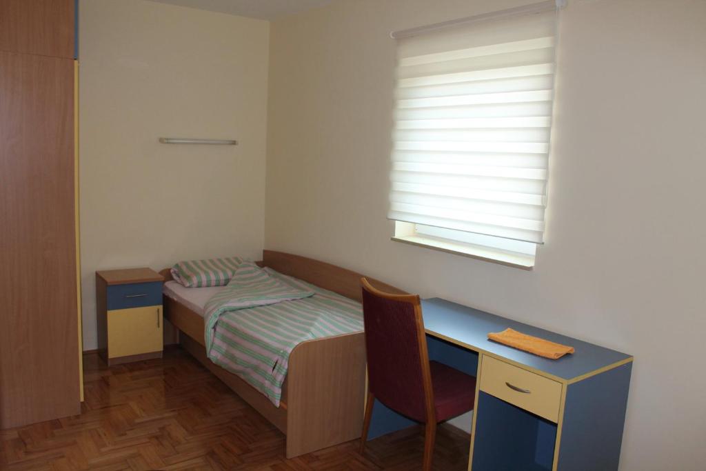 Postel nebo postele na pokoji v ubytování Hostel Teresianum
