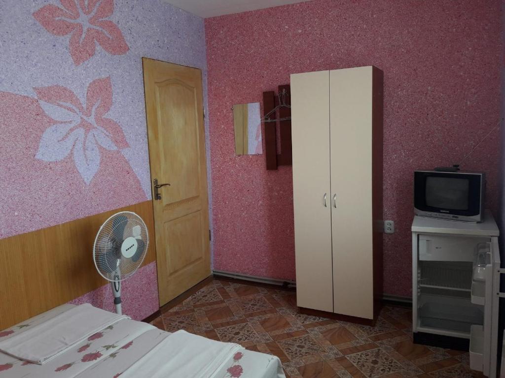 ベルジャーンシクにあるГостевой дом на Лискахのベッドルーム1室(ベッド1台、テレビ付)