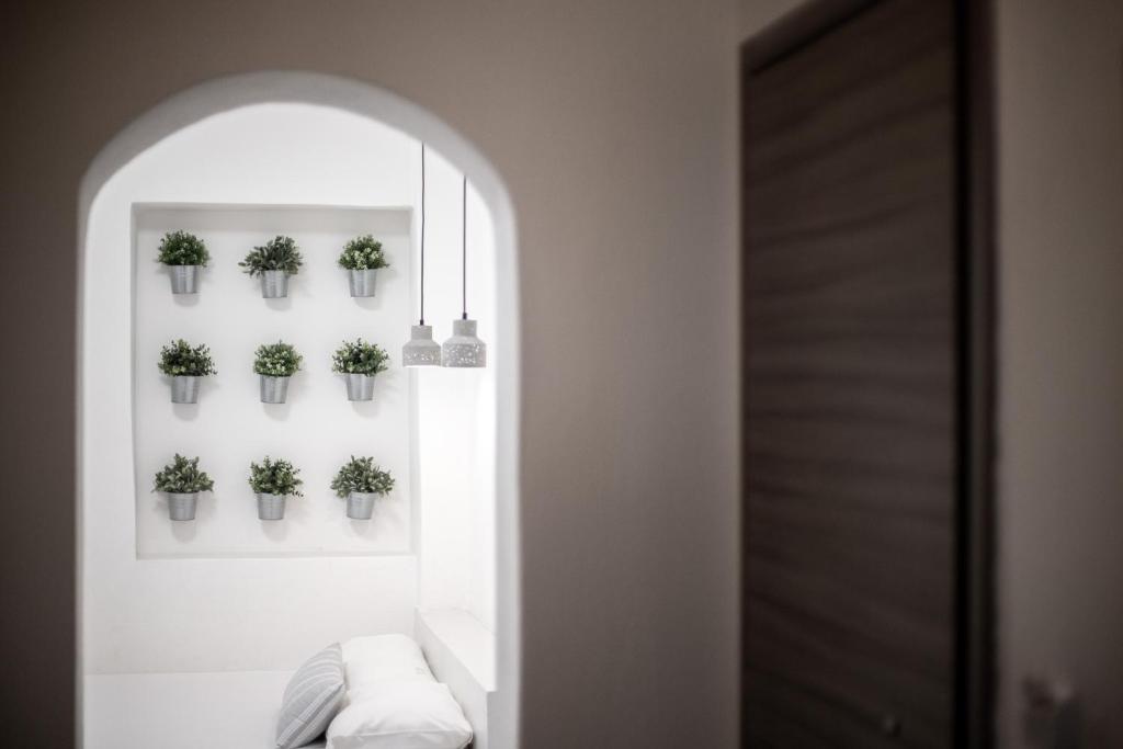 a hallway with potted plants on the wall at Kokkinos in Vourvourou