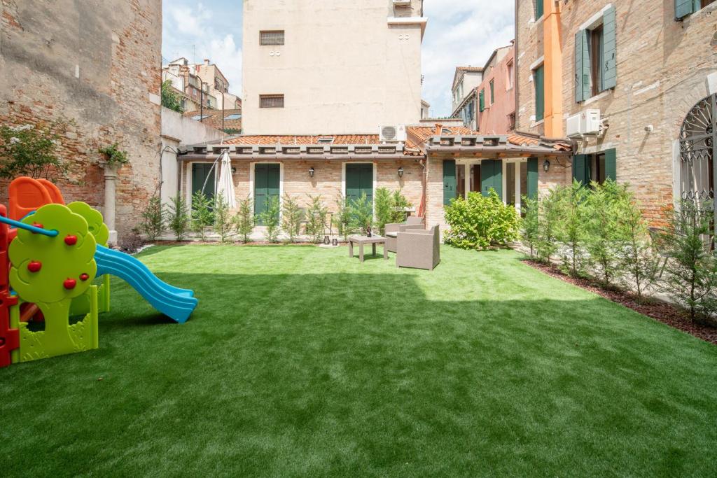 a yard with a playground in the middle of a building at Corte dei Santi in Venice