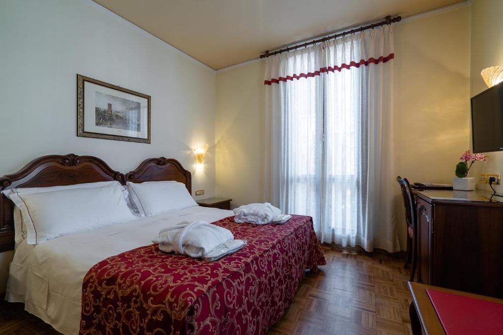 Postel nebo postele na pokoji v ubytování Hotel Spessotto