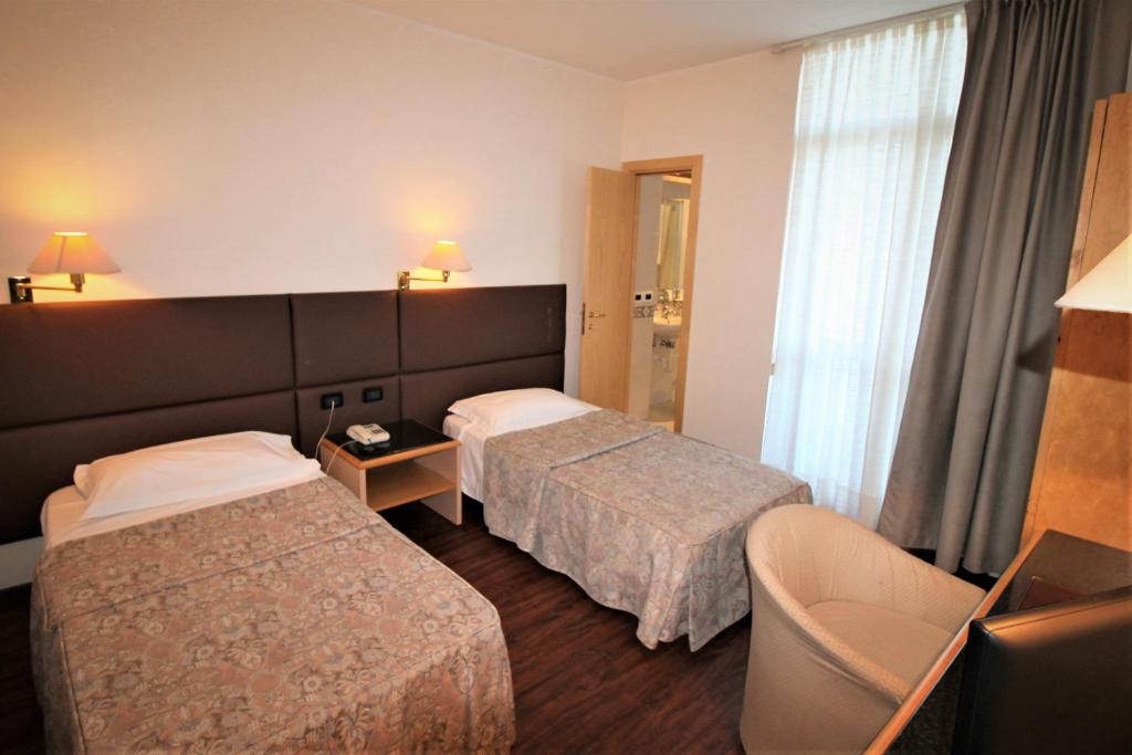 Postel nebo postele na pokoji v ubytování Hotel Minerva