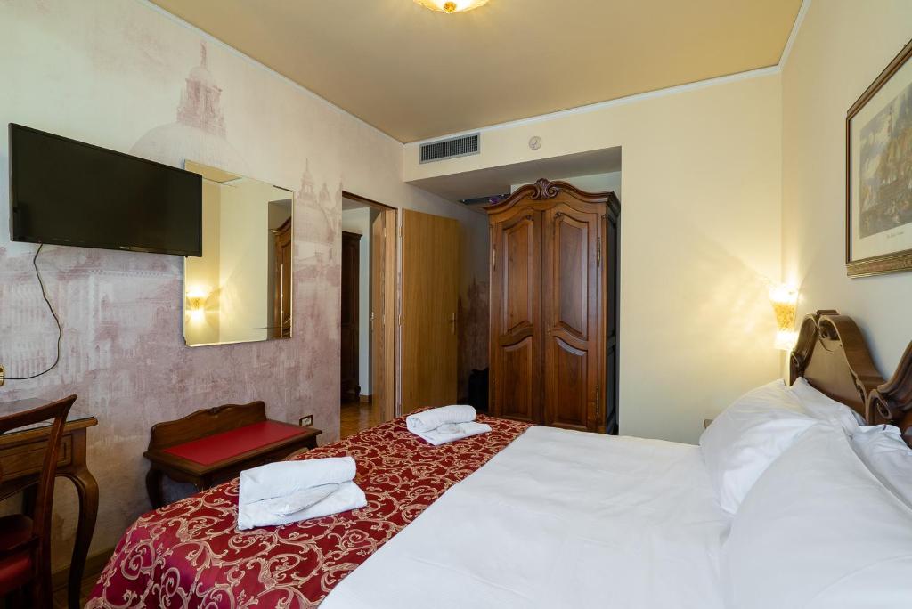 Postel nebo postele na pokoji v ubytování Hotel Spessotto