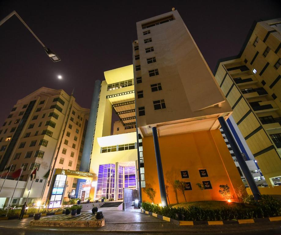 a group of buildings in a city at night at The Juffair Grand Hotel in Manama