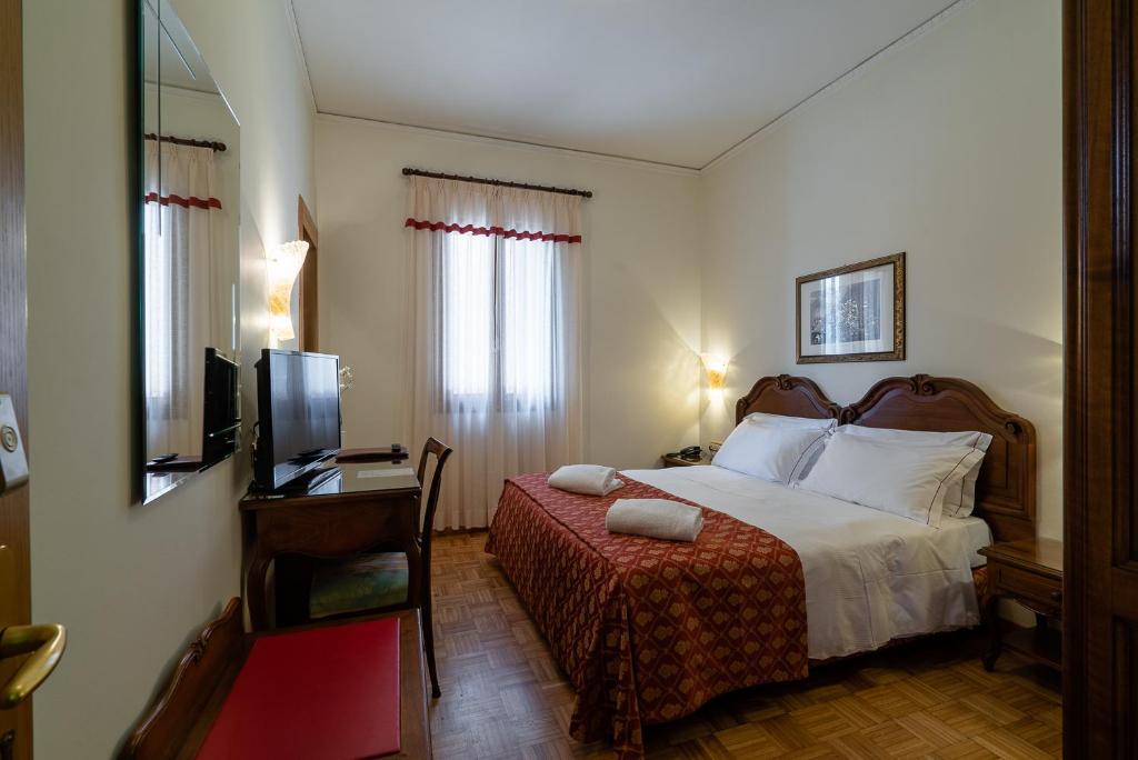 Postel nebo postele na pokoji v ubytování Hotel Spessotto