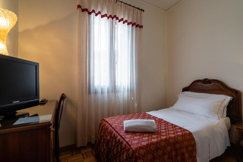 Postel nebo postele na pokoji v ubytování Hotel Spessotto
