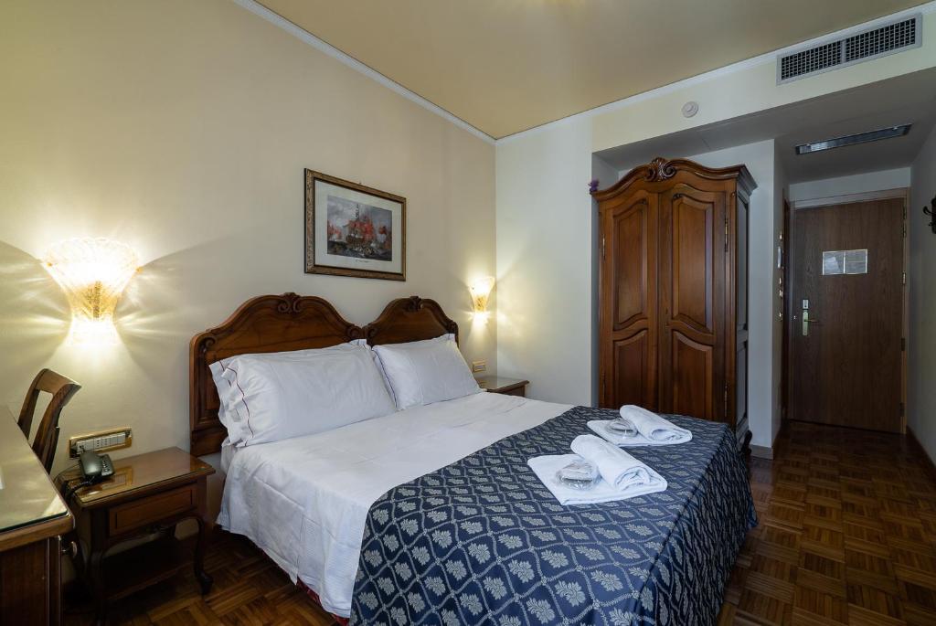 Postel nebo postele na pokoji v ubytování Hotel Spessotto