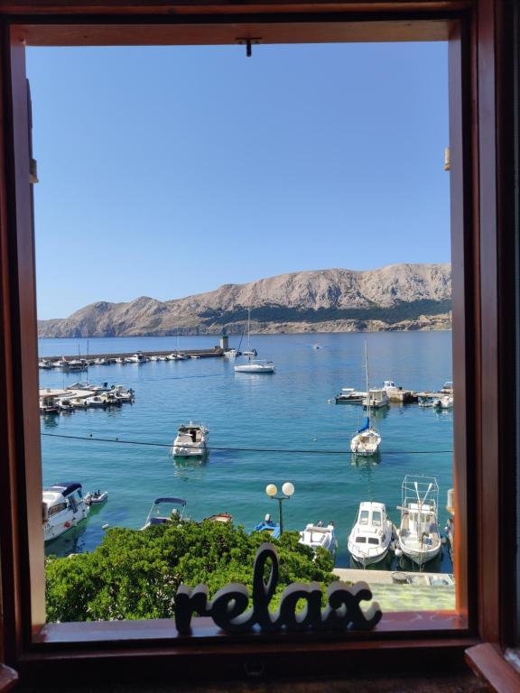 a window with a view of a marina at Margarita in Baška