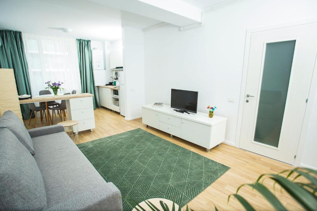 a living room with a couch and a tv at Residence DP Pipera in Bucharest