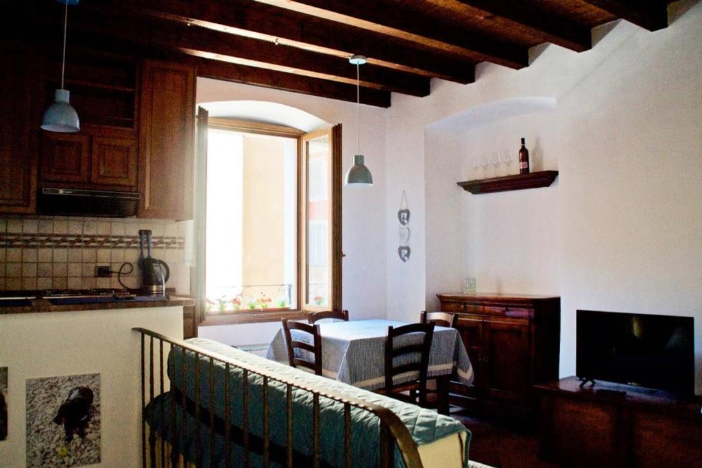 a kitchen and living room with a table and chairs at Casa Francesca in Gargnano