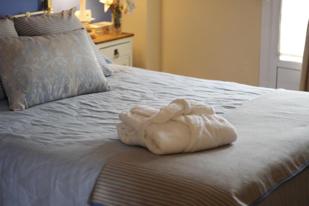 a white towel is laying on a bed at Casa Rural Francisco Pizarro in Herrera del Duque