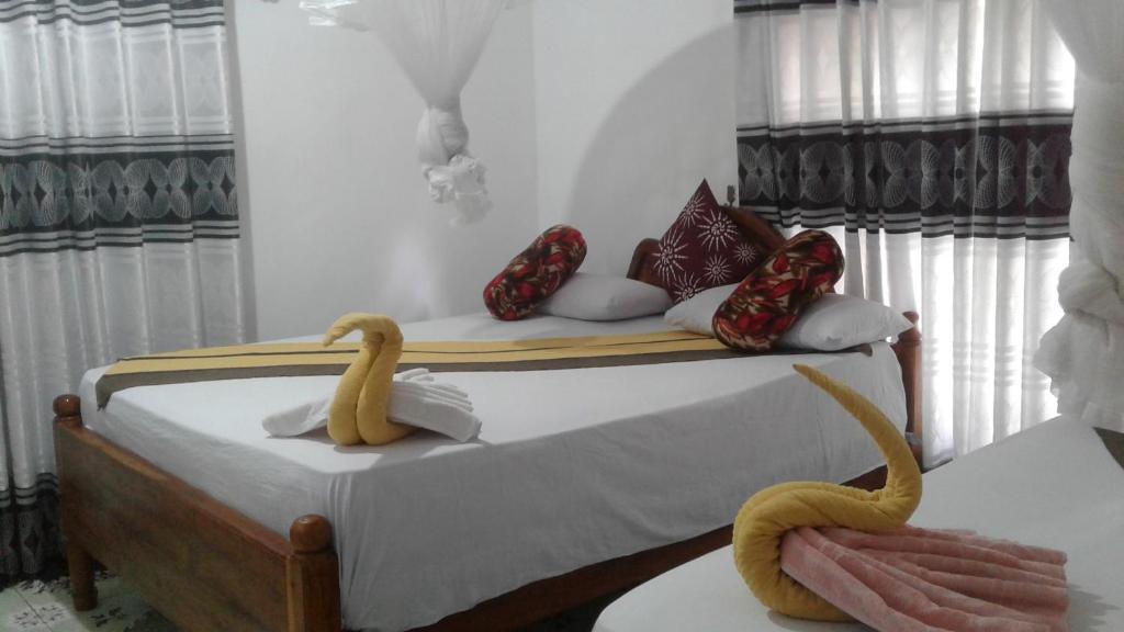 Postel nebo postele na pokoji v ubytování Kalana Homestay