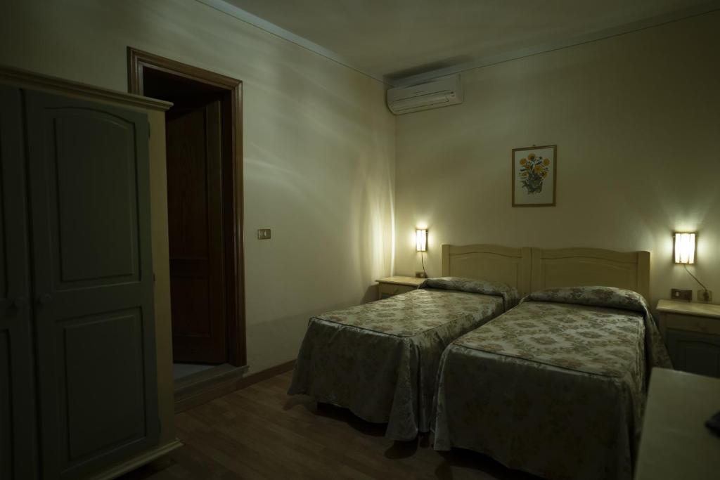 Postel nebo postele na pokoji v ubytování Hotel Mediavalle