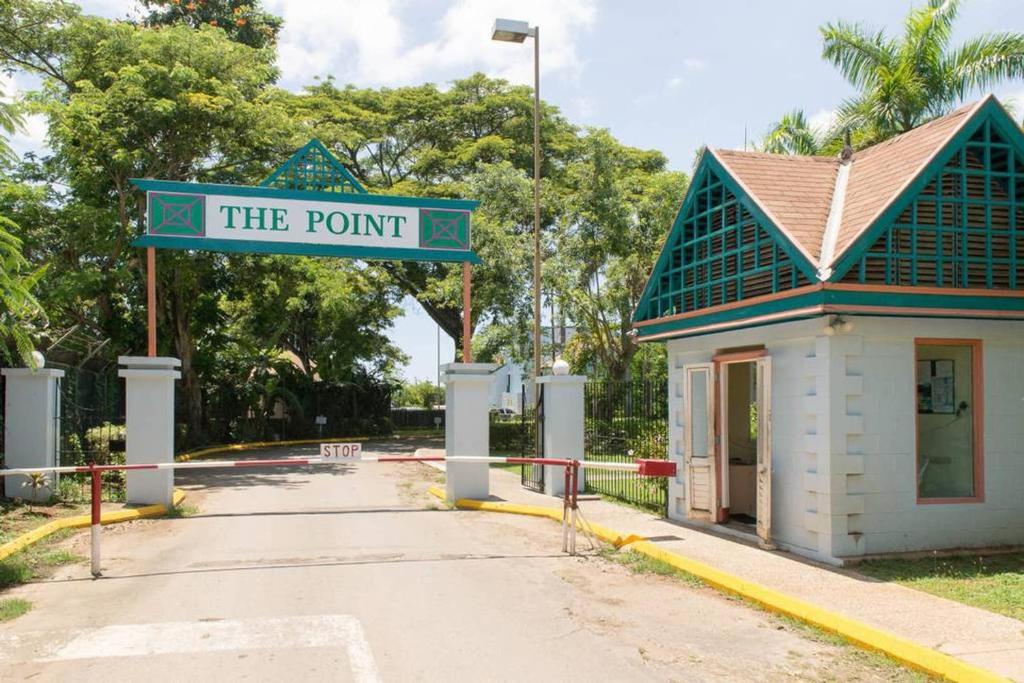 a street sign that reads the point in front of a building at The Point in Orange Bay