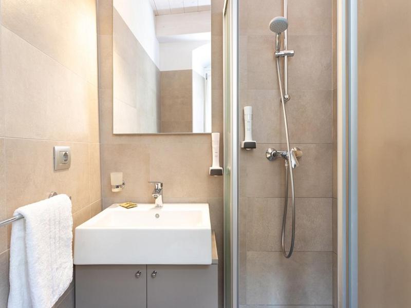 a bathroom with a sink and a shower with a mirror at Locanda Le Due Travi in Trento