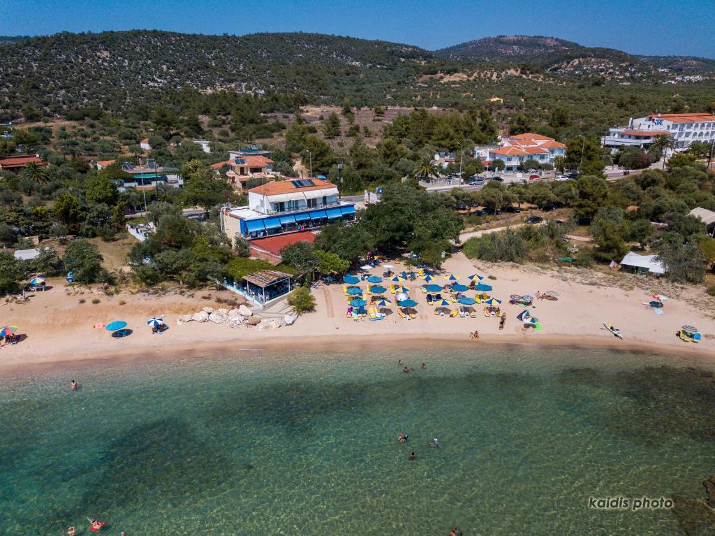 an aerial view of a beach with people and umbrellas at Astris Beach in Astris