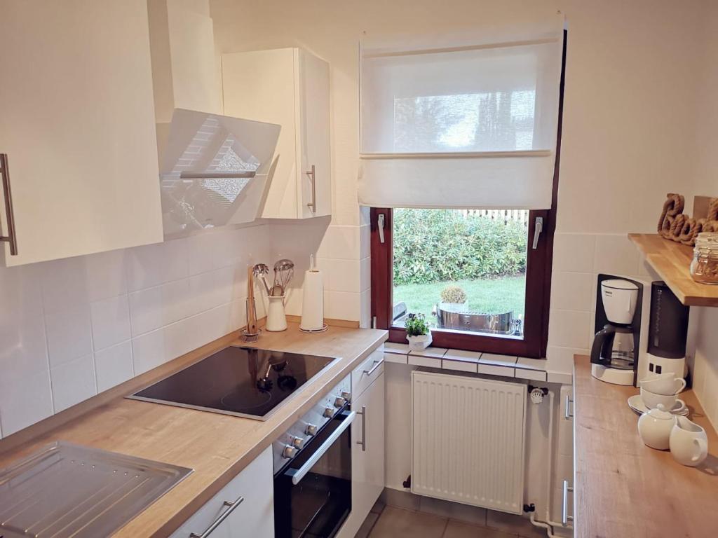 a kitchen with a sink and a window at Baltrumweg 4 in Wangerland