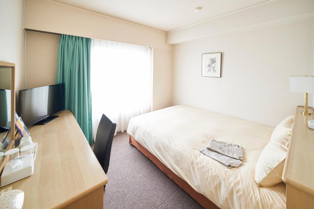 TV a/nebo společenská místnost v ubytování AkishimaStationHotel TOKYO