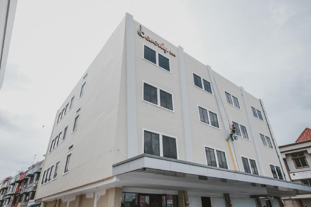 a white building with a sign on the top of it at RedDoorz Plus near Ferry Terminal Batam Center in Batam Center