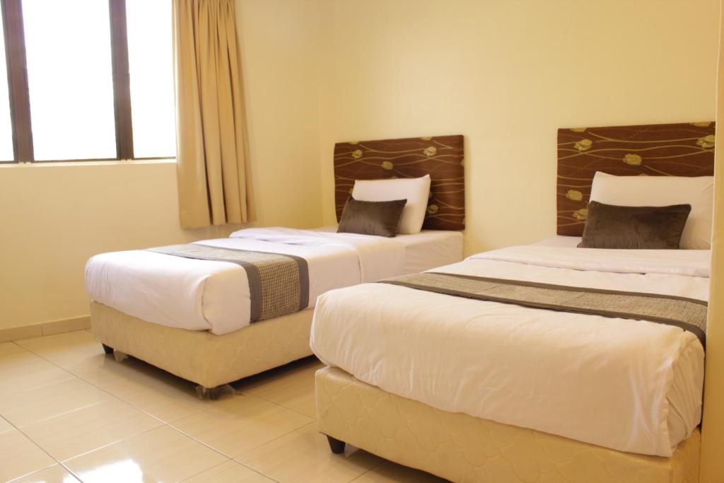 Postel nebo postele na pokoji v ubytování Hotel Bandar Baru Menglembu