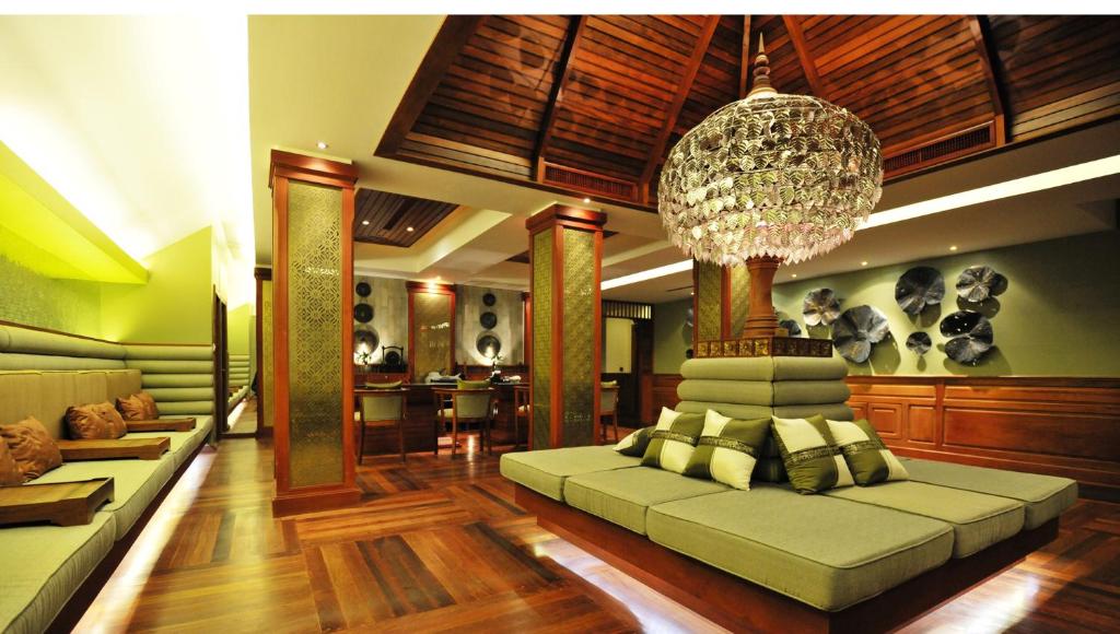 a living room with a couch and a chandelier at THE PRIVILEGE FLOOR by Borei Angkor in Siem Reap