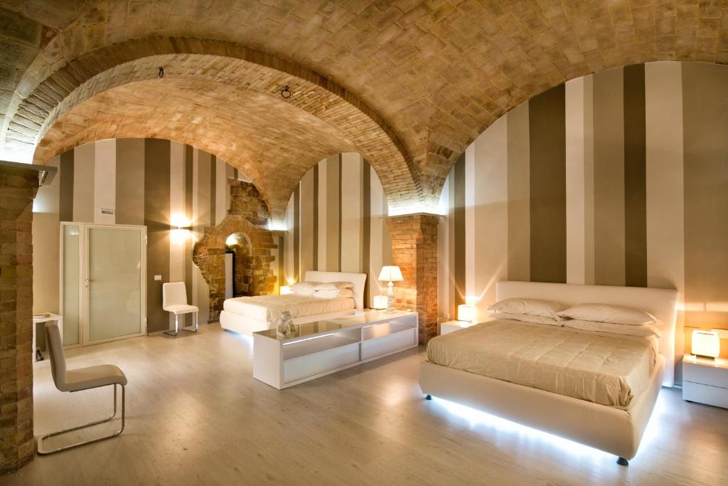 Posteľ alebo postele v izbe v ubytovaní Hotel Degli Affreschi