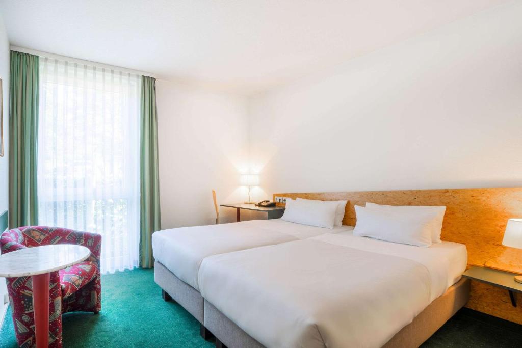 Postel nebo postele na pokoji v ubytování Quality Hotel Hof