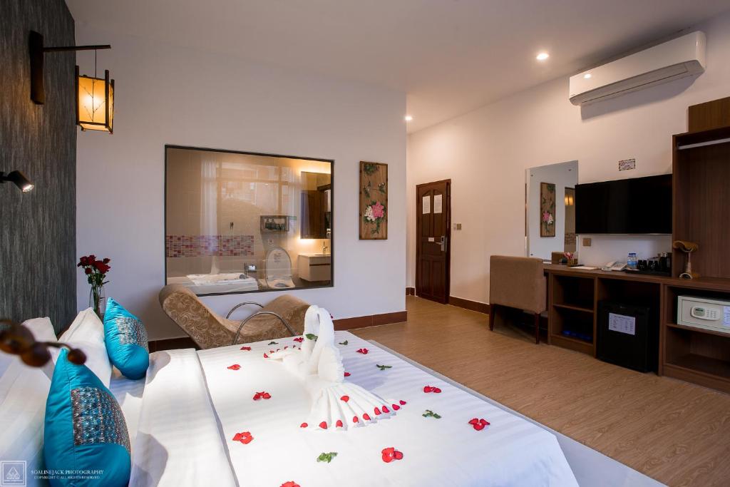 a living room with a white couch with flowers on it at Orussey One Boutique in Phnom Penh