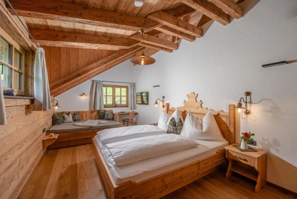 a bedroom with a large bed and wooden ceilings at Almchalet Linharterhof in Haus im Ennstal