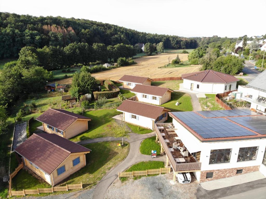 an aerial view of a house with solar panels on it at Carolinger Hüttendorf in Weyer