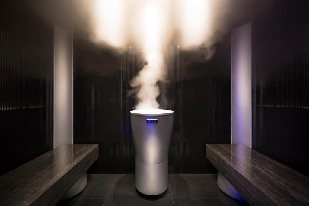 a bathroom with a toilet with smoke coming out of it at Hotel Vinotel Gospoja in Vrbnik