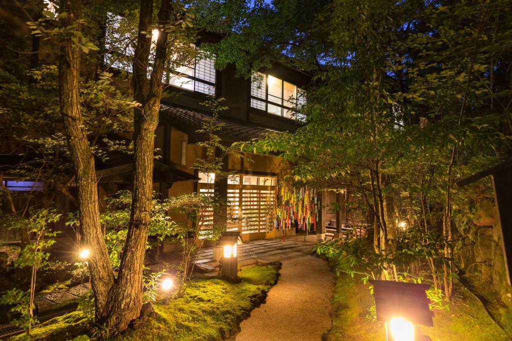 a walkway in front of a building with lights at Ryokan Wakaba in Minamioguni