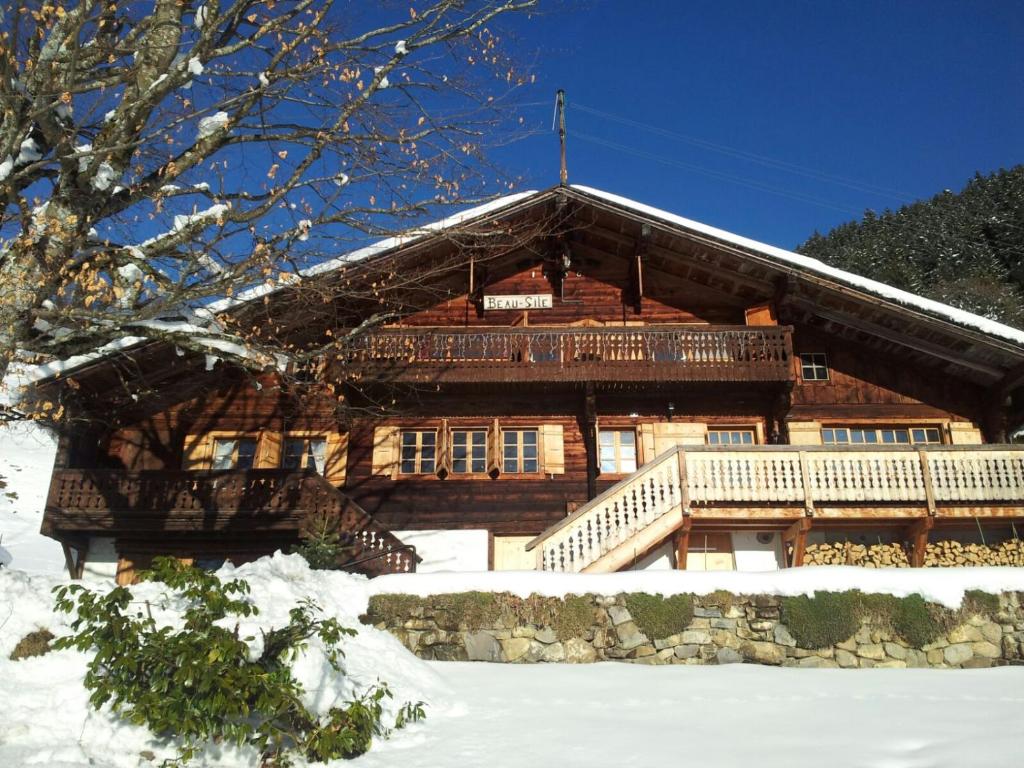 a large wooden house with snow on the ground at Chalet Beau Site in Le Sépey