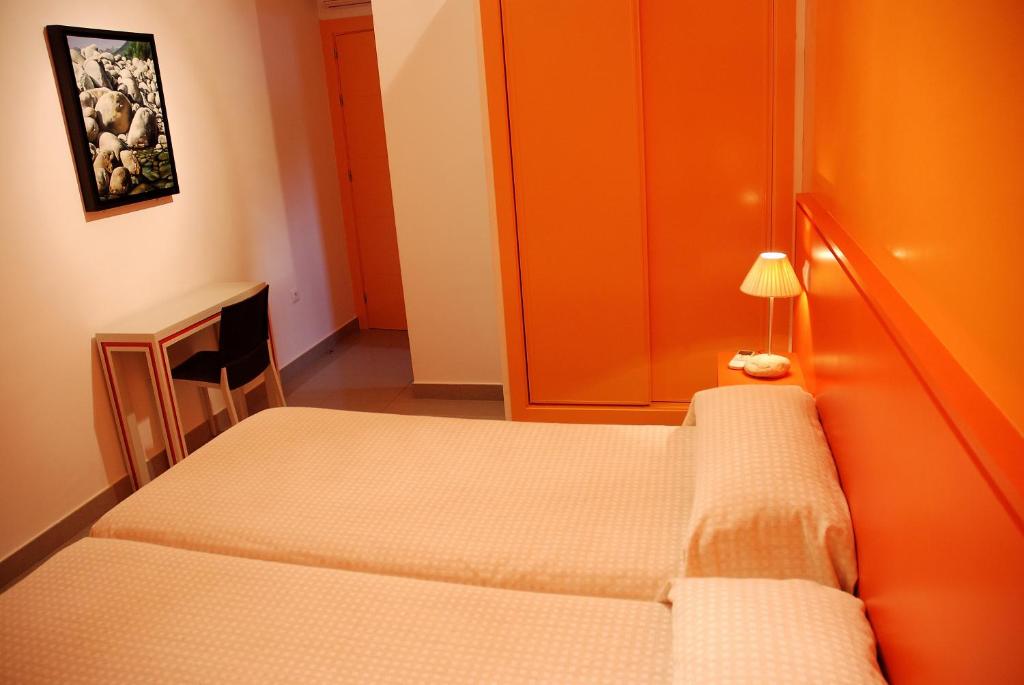 Postel nebo postele na pokoji v ubytování Hostal El Cardenillo