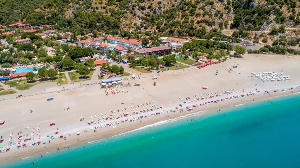 an aerial view of a beach with a crowd of people at Belcekum Beach Hotel in Oludeniz