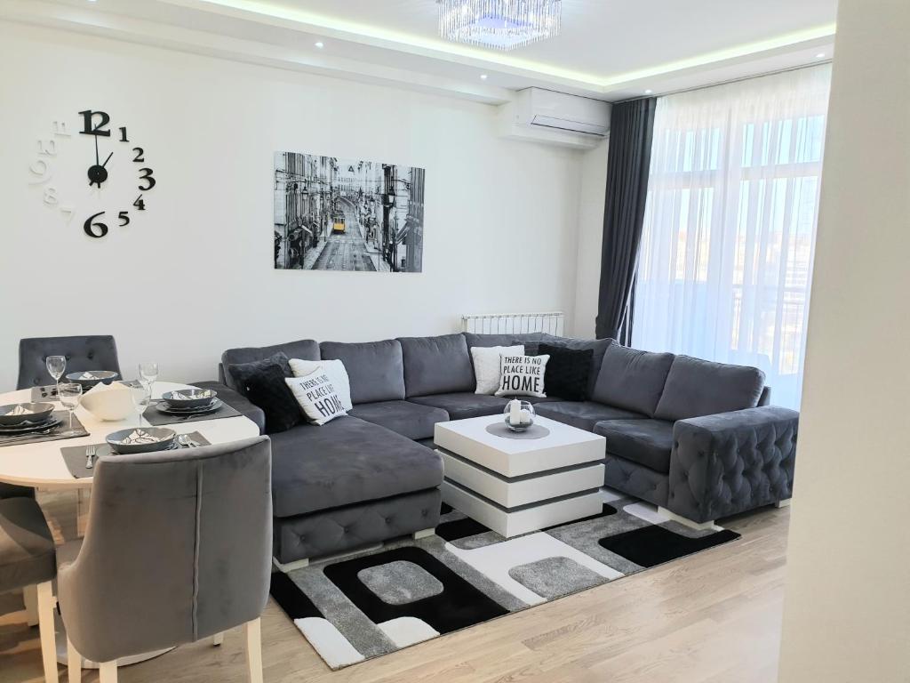 a living room with a couch and a table at Belgrade Waterfront-Delux apartman Beograd na vodi in Belgrade