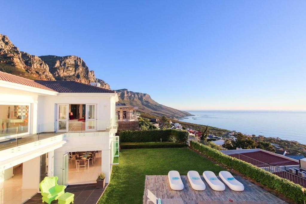 a house with a view of the ocean at La Maison Hermes - Heated Saltwater Pool in Cape Town