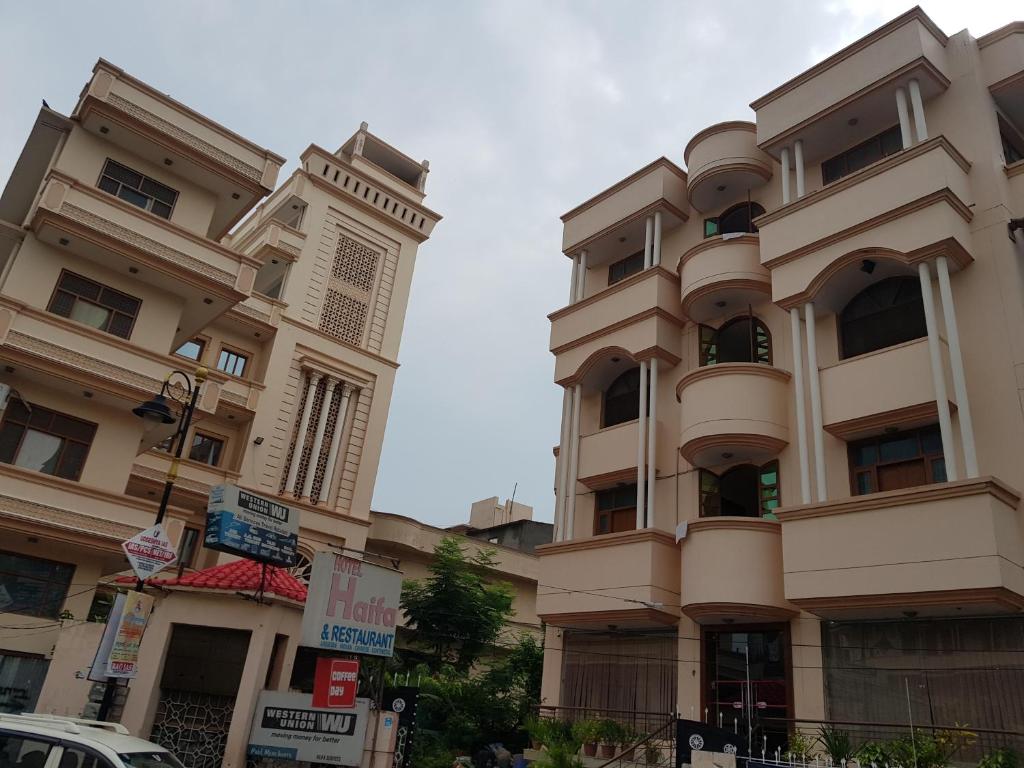 a building with a clock tower on the side of it at HOTEL HAIFA in Varanasi