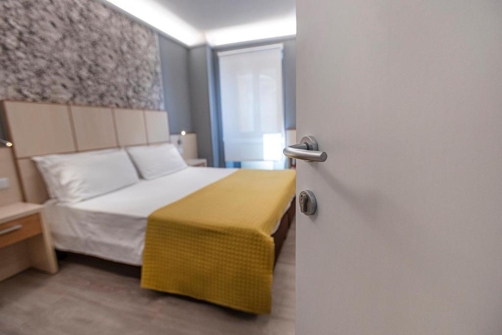 Postel nebo postele na pokoji v ubytování Albergo Aurora