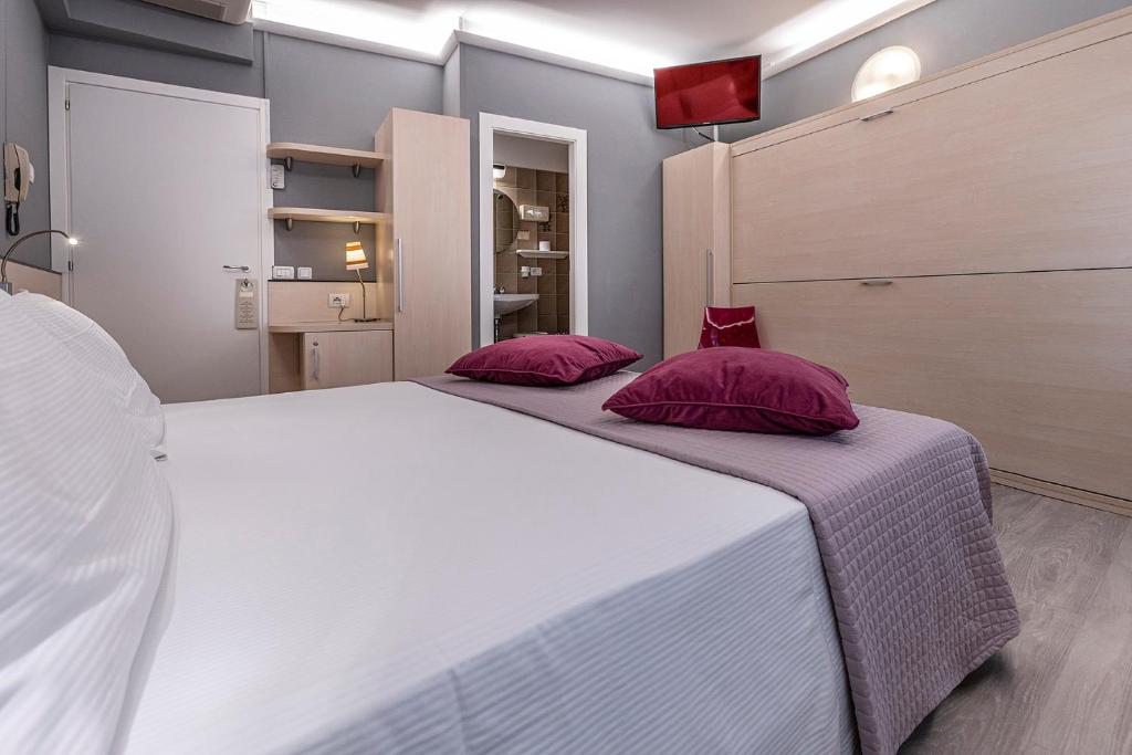 Postel nebo postele na pokoji v ubytování Albergo Aurora