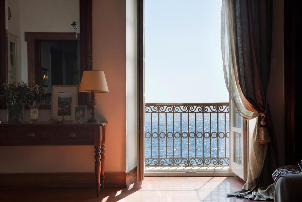 a room with a window with a view of a balcony at Xenon Apollonos in Ermoupoli