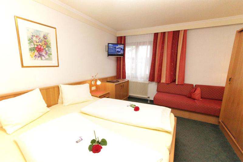 Postel nebo postele na pokoji v ubytování Hotel Mitterer