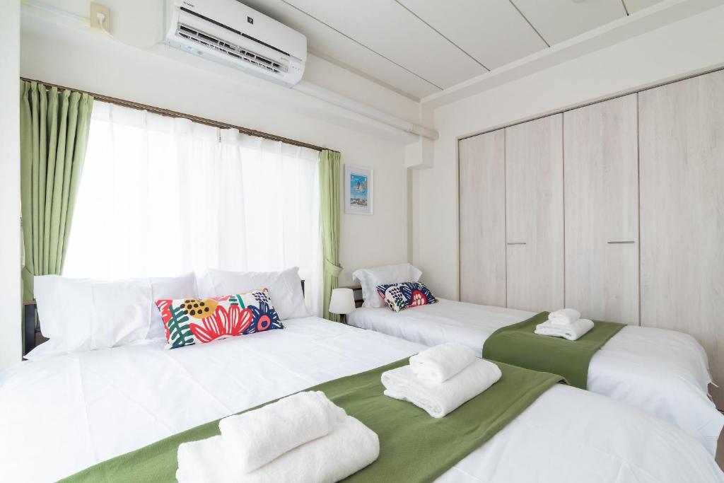 Postel nebo postele na pokoji v ubytování Uhome Iriya Apartment