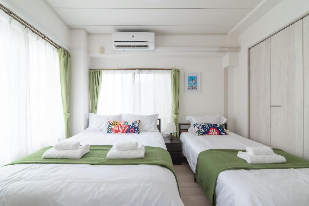 Postel nebo postele na pokoji v ubytování Uhome Iriya Apartment