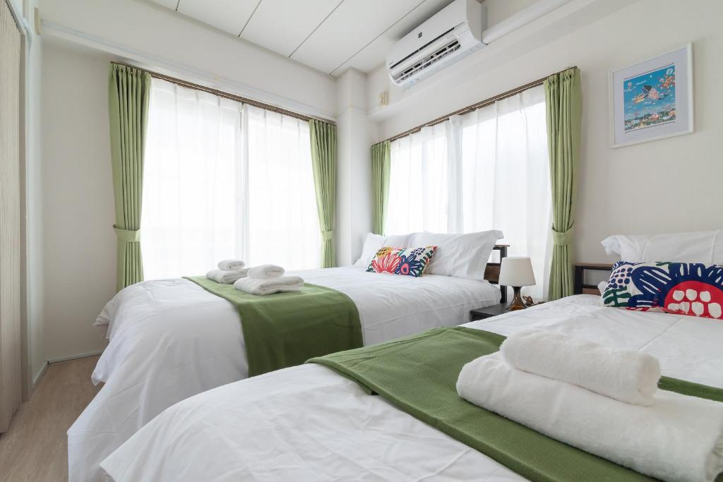 Postel nebo postele na pokoji v ubytování Uhome Iriya Apartment