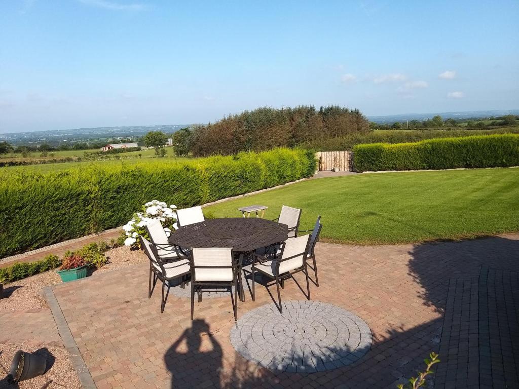 a table and chairs sitting on a brick patio at Antrim Heights B&B Panoramic Views & Free Parking in Antrim