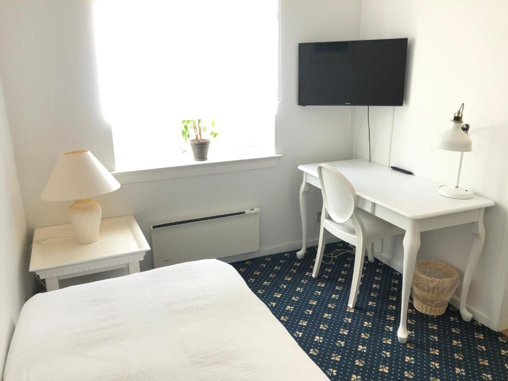 Postel nebo postele na pokoji v ubytování Ølsted Kro